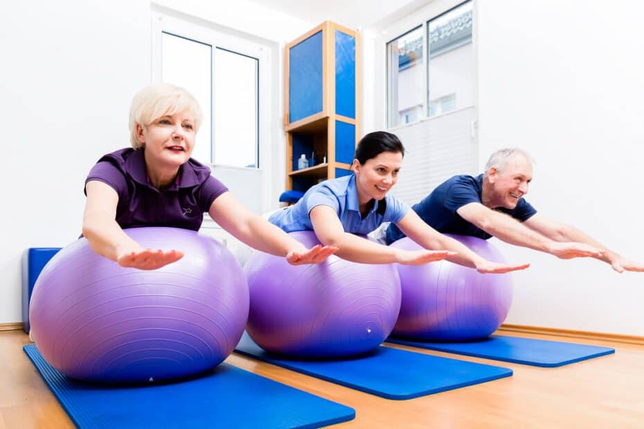 36346246 physio showing senior couple how to use gym ball for exercisesS