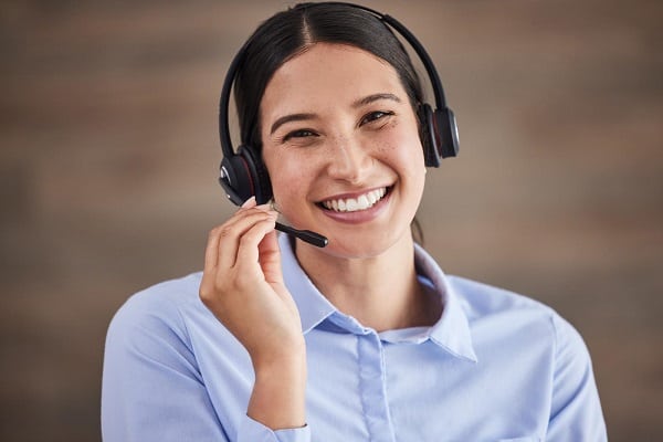 47499666 face of businesswoman working in a call center customer service operator wearing a headset portrait of happy service rep it customer service rep smiling customer service agent on a call