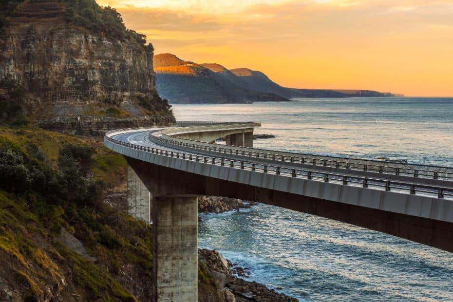 sunset sea cliff bridge along australian pacific ocean